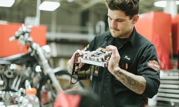 Man Maintaining Motorcycle