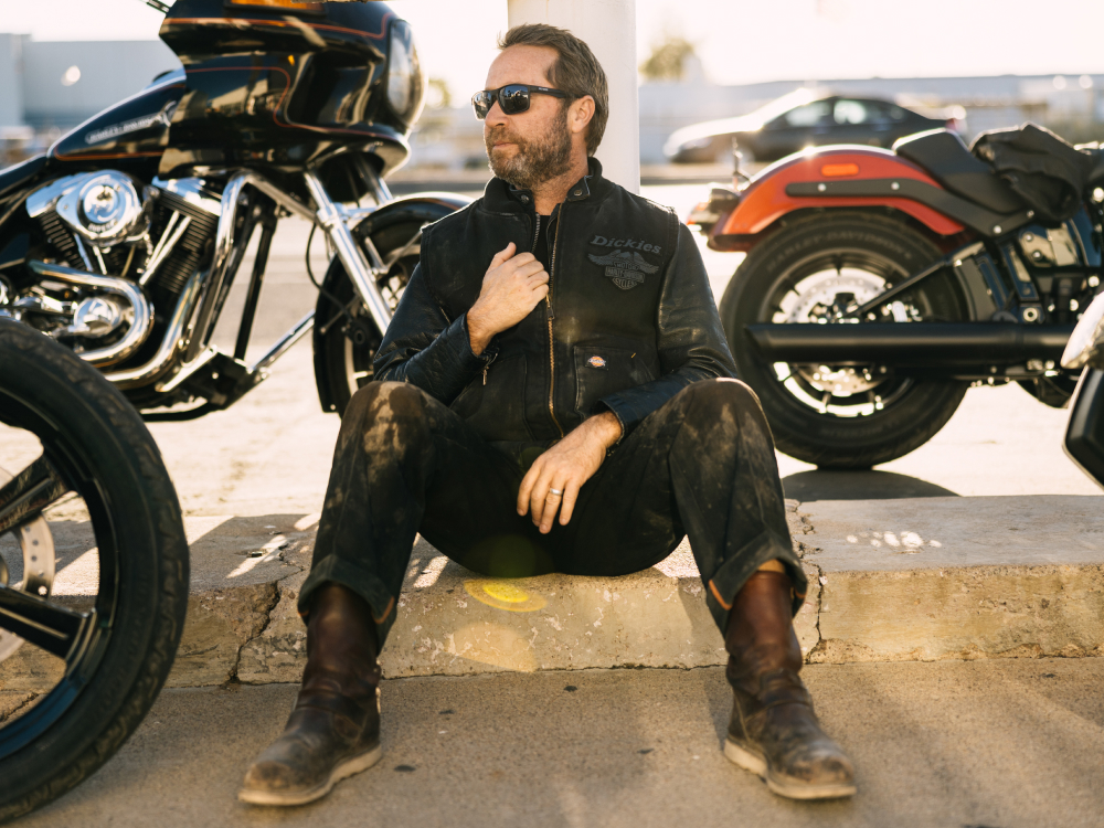 Man sitting on curb near motorcycles