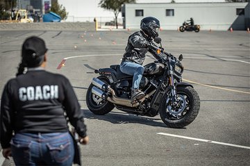 Motorcycle rider with coach on training range