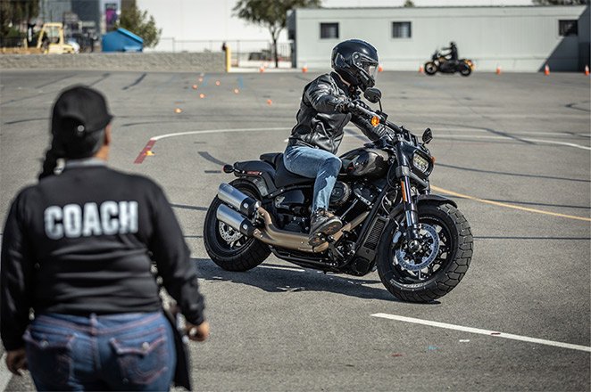Motorcycle rider with coach on training range