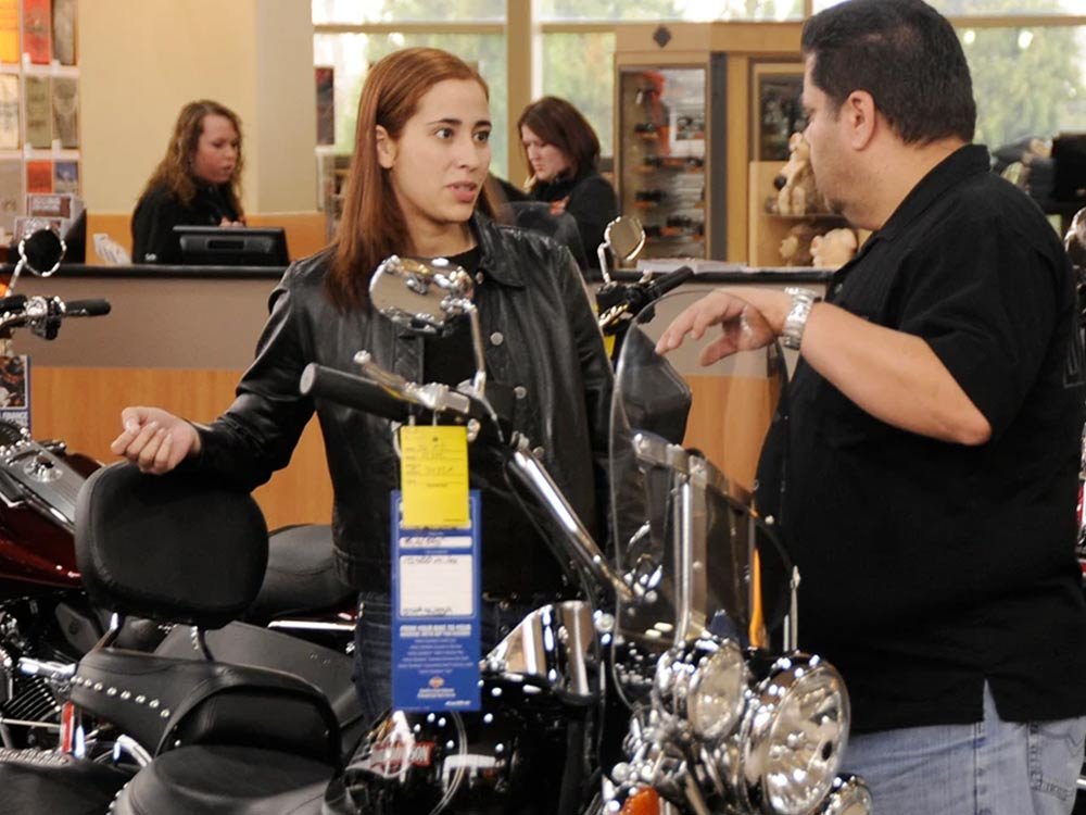 Customer taking to a salesperson at a dealer showroom