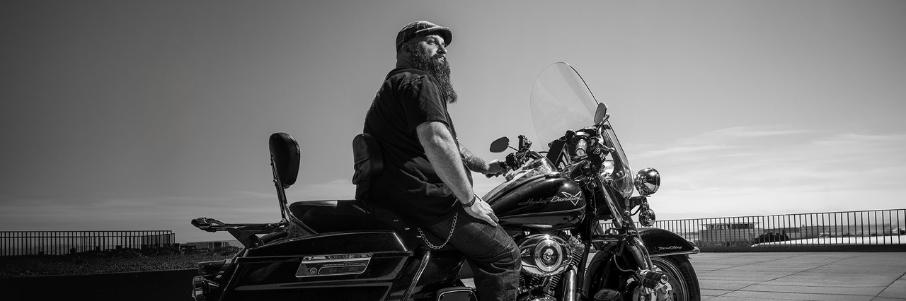 Motorcycle rider sits on bike