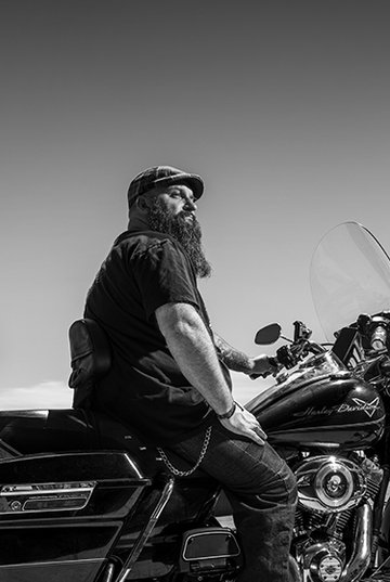 Motorcycle rider sits on bike